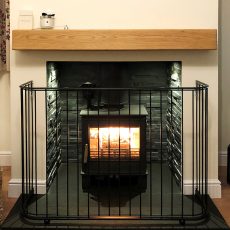 Contemporary Fireguard for black log burning stove on a slate hearth
