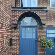 Aged roman door canopy over a front door