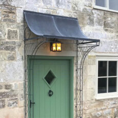 Zinc galvanized traditional porch canopy with wirework sides over front door