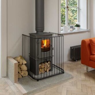 A contemporary hand made steel fireguard around a log burner