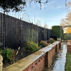 A garden fence with English wirework trellis panels