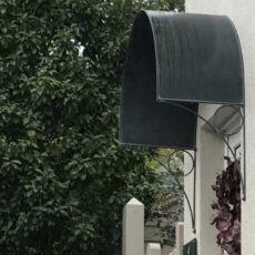 a black metal front door canopy