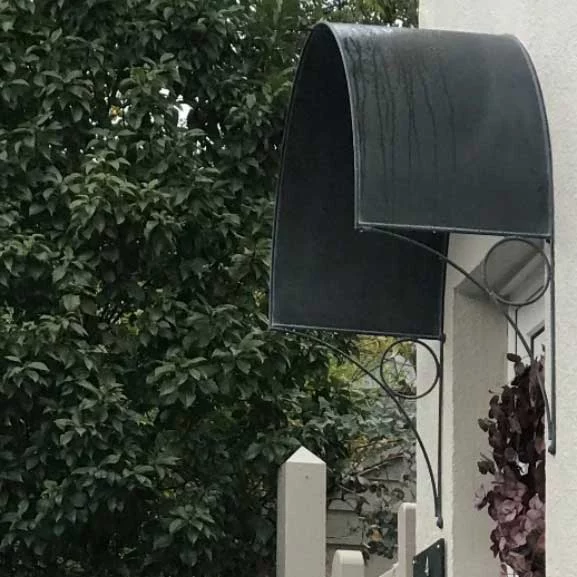 a black metal front door canopy
