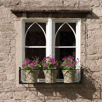 zinc-wire-mesh-window-box a small wire work window box holding three flowering plants